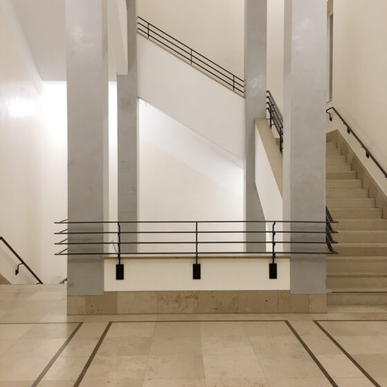Moderne Treppenhaus-Architektur mit klaren Linien und neutralen Farben.