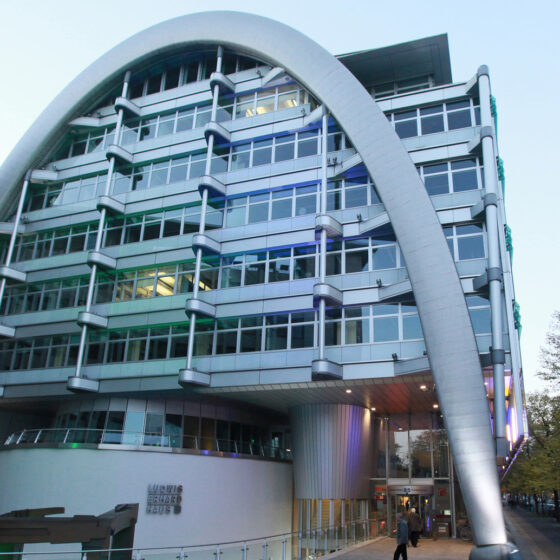 Ludwig Erhard Haus in Berlin mit markantem Bogen in urbaner Umgebung.