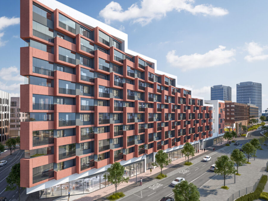 Moderne Wohnanlage in urbaner Umgebung mit roter Fassade und großen Fenstern.