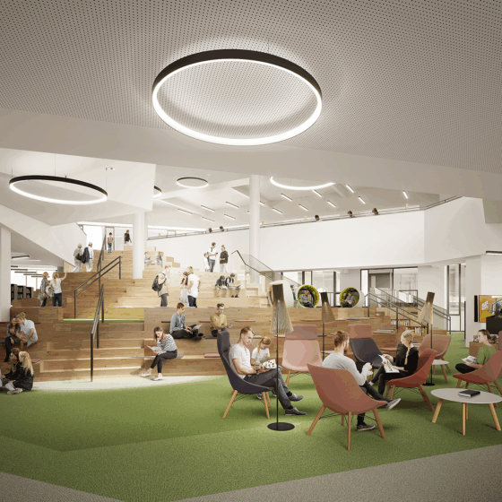 Moderne Bibliothek mit offenen Räumen, Sitzgelegenheiten und Lernbereichen für Studierende.