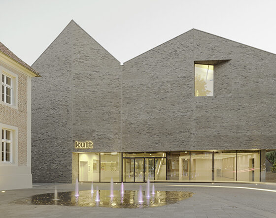 Moderne Architektur des kult Gebäudes mit Wasserfontänen und historischem Hintergrund.