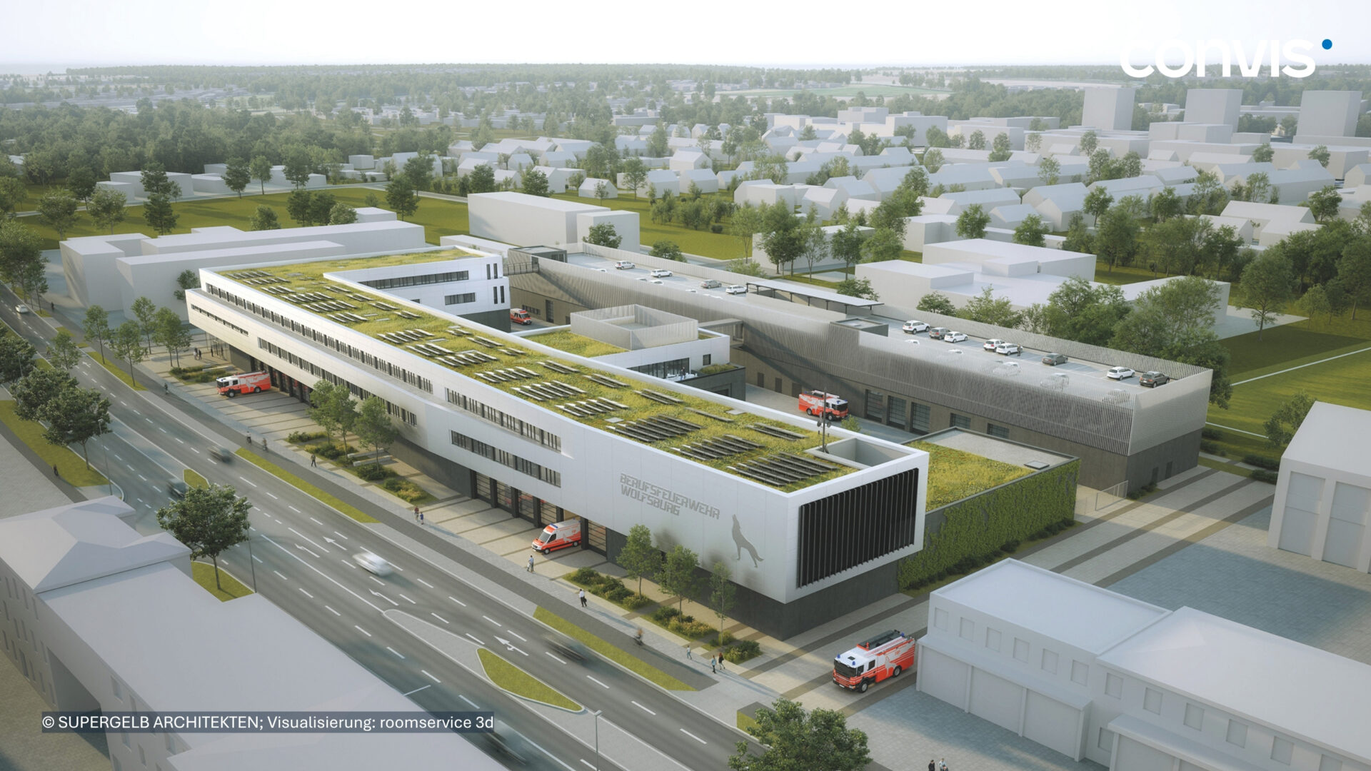 Moderne Architektur eines Rettungszentrums mit begrünten Dächern und Notfallfahrzeugen.