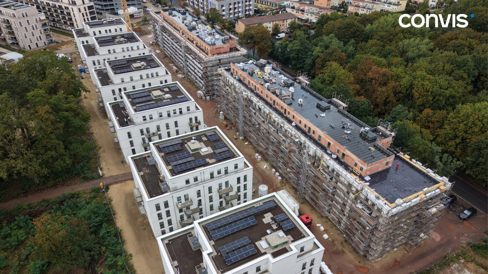 Bauprojekt mit modernen Wohngebäuden und Solaranlagen in urbaner Umgebung.